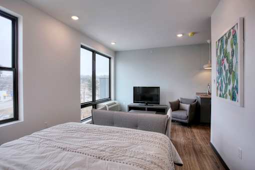 Studio with bed sofa and television lounge area at The Traveler Apartments, Omaha