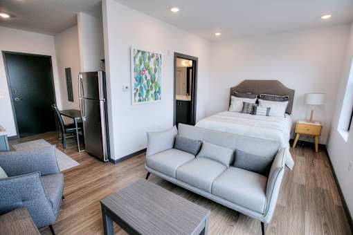 Studio with bed sofa and refrigerator at The Traveler Apartments, Nebraska