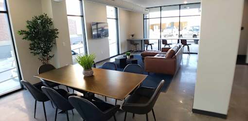A conference room with a long table and chairs.