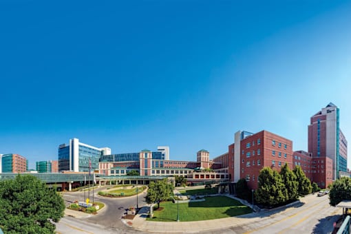 A hospital complex with a mix of modern and older buildings.
