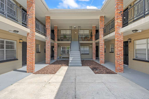 a stairway leading up to an apartment building