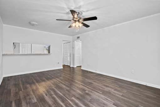 a bedroom with hardwood floors and a ceiling fan