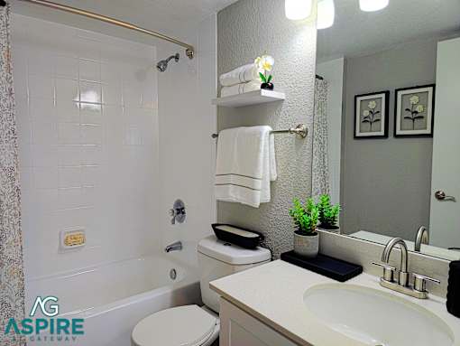 A white toilet with a white towel hanging on a towel rack.