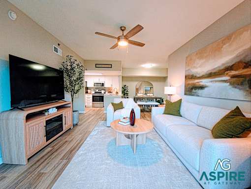 A living room with a television, a couch, and a coffee table.