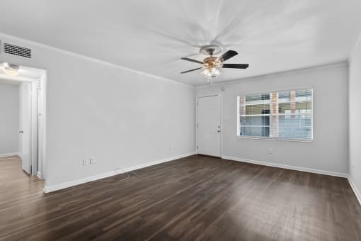 a bedroom with hardwood floors and a ceiling fan