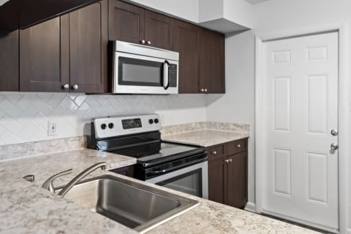 a kitchen with a sink oven and microwave