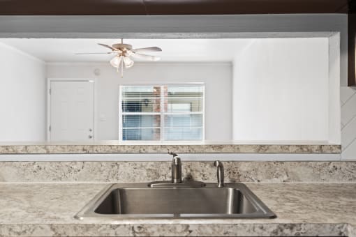 a kitchen with granite countertops and a sink