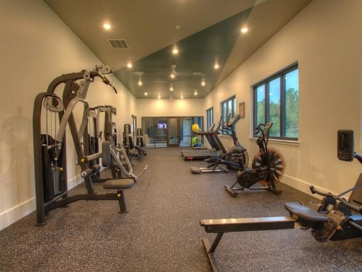 a gym with weights and exercise equipment in a large room