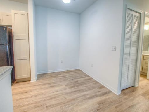 an empty room with blue walls and closet doors
