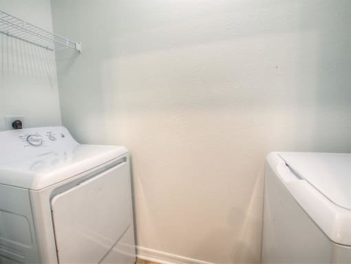 a white washer and dryer in a laundry room with a white dryer