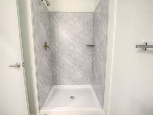 a small bathroom with a shower and a sink