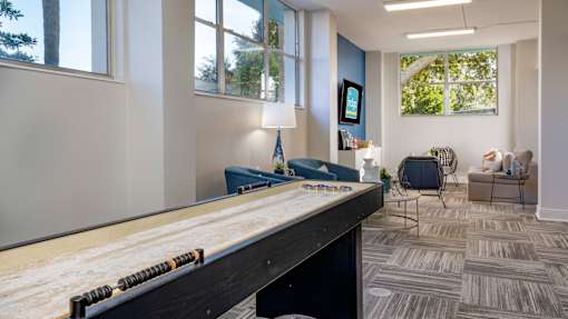 A room with a pool table and a chair.
