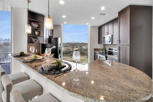 Modern kitchen with stainless steel appliances & sleek finishes at Med Center in Houston, TX.