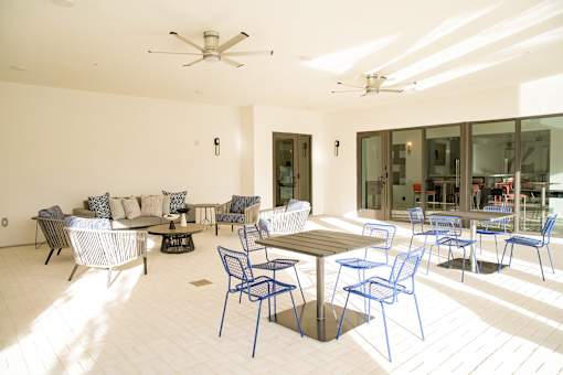 A white room with blue chairs and a table.