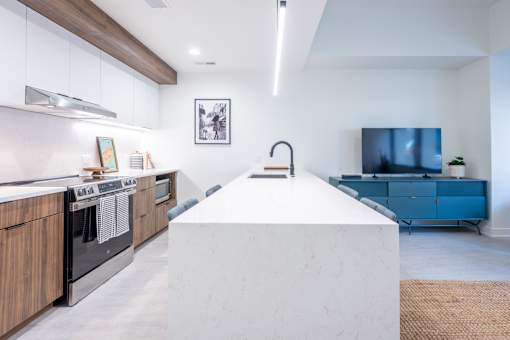 A modern kitchen with a white island in the middle.