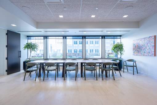 A conference room with a long table and chairs.