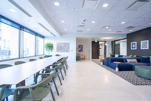 A conference room with a long table and chairs.