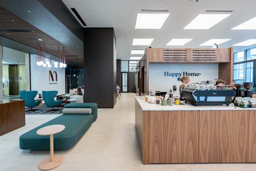 A modern office space with a reception desk and seating area.