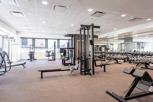 A gym with a variety of equipment including a leg press machine.