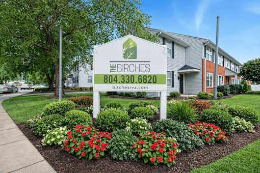 A sign for Birches with a phone number and website on it.