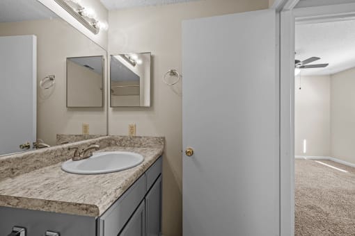 an empty bathroom with a sink and a mirror