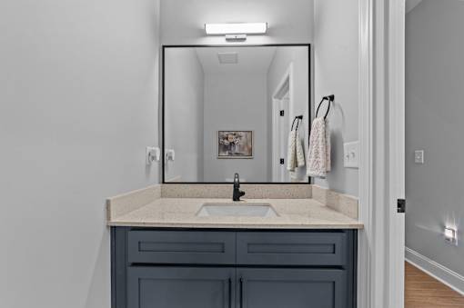A bathroom with a sink and a mirror.at Regency Townes, Winterville, 28590  