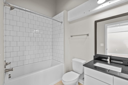a white bathroom with a white toilet and a tub and a sink at Spinning Mill Lofts, Clayton, NC 27520