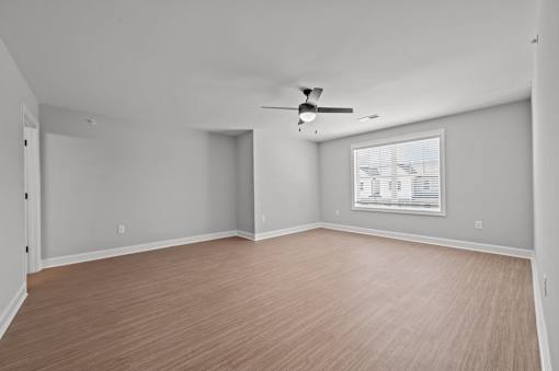 A room with a ceiling fan and a window with blinds.at Regency Townes, North Carolina, 28590 