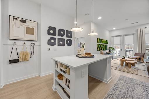 A white kitchen island with a wooden top and shelves below it.at Adler Montford Park + Drexel Townes, Charlotte, NC, 28209