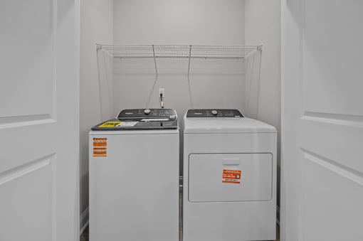Two white appliances in a white room.