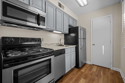 a kitchen with stainless steel appliances and white cabinets