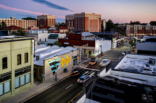 A city street with cars and buildings.