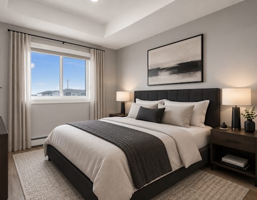 A bedroom with a large bed and a window overlooking a snowy landscape.