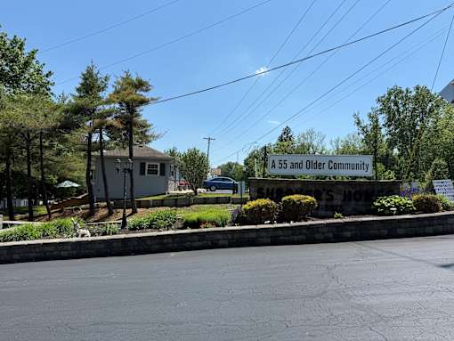 A55 and Older Community sign in front of a house.