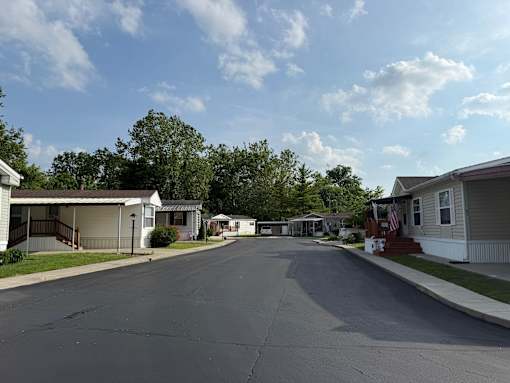 A street view of a residential area with houses on both sides.