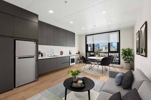 A modern kitchen with a dining area and a view of the city.