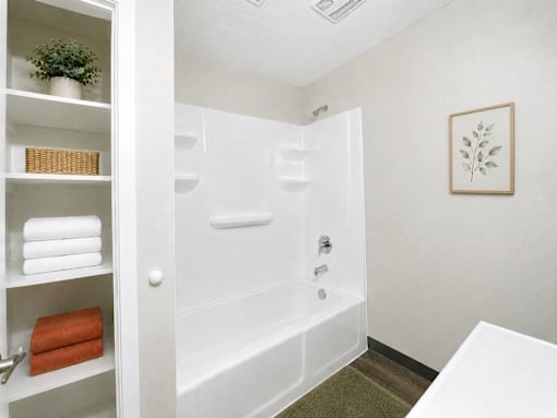 A white bathroom with a white tub and a white door.