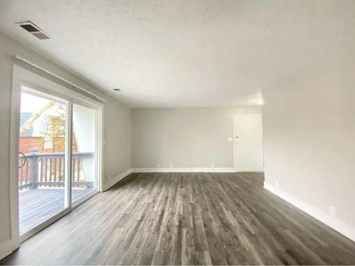 A room with a wooden floor and white walls.