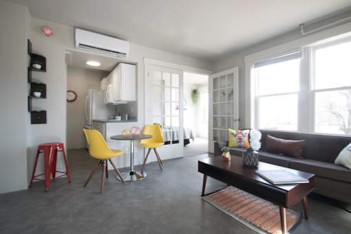 A modern living room with a grey floor and furniture.
