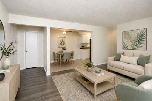 A living room with a couch, chairs, and a coffee table.