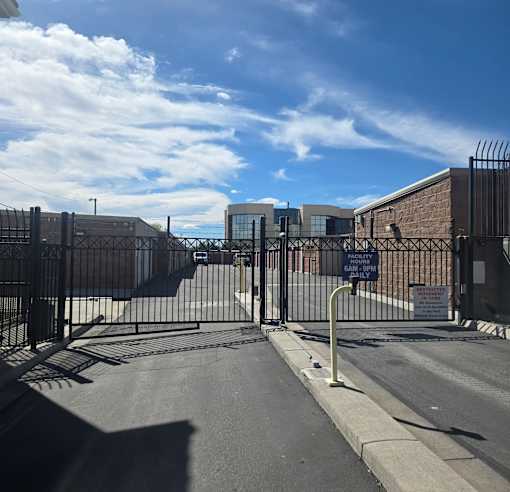 A gated entrance to a facility with a sign that reads "Sensitive Material Handling Only".