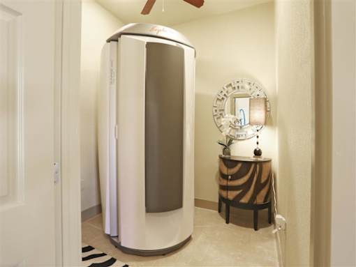 A white and silver steamer in a bathroom.