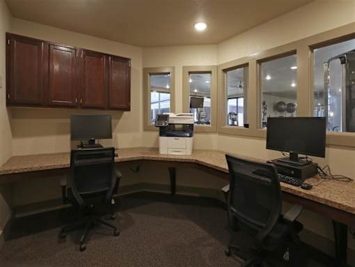 A room with two chairs and two monitors.