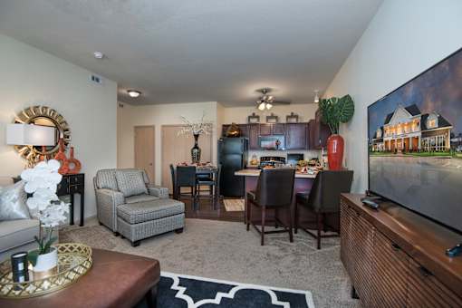 A living room with a grey couch, a brown coffee table, and a large painting on the wall.
