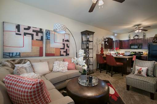 A living room with a couch, a table, and a painting on the wall.