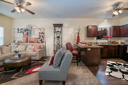 A living room with a grey armchair and a coffee table.