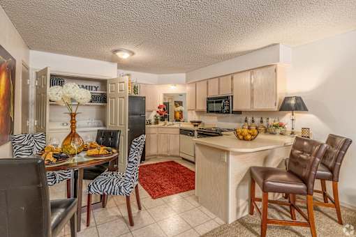 a kitchen and dining room with a table and chairs