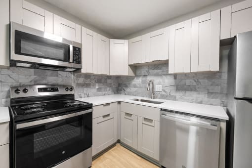 Kitchen with stainless steel appliances and shaker-style cabinets