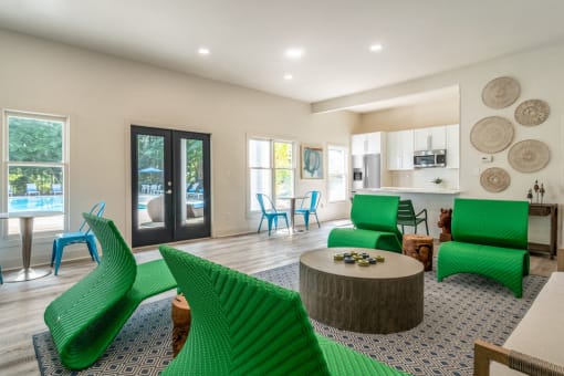 a living room with green chairs and a table