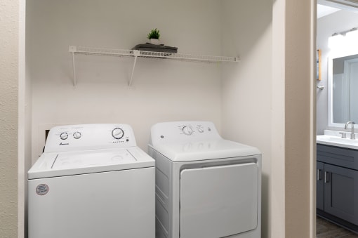 a washer and dryer in a laundry room with a sink